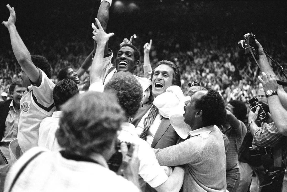 In this June 9, 1982, file photo, Los Angeles Lakers head coach Pat Riley, center right, is swamped by fans and players as he and Lakers Mike Cooper leave the court after defeating Philadelphia 76ers 114-104 to win the NBA championship. Riley, the current Miami Heat president, has stockpiled nine championship rings, became a best-selling author and motivational speaker, transformed the fashion sense of NBA coaches and left an indelible mark on franchises in Los Angeles, New York and Miami. And he's not done.