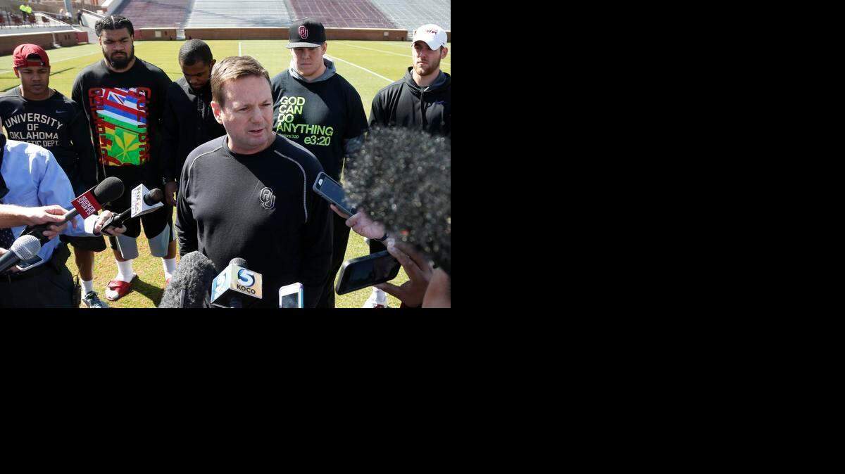 
Oklahoma head coach Bob Stoops, center, answers a question for the media following a demonstration by the Oklahoma football team against racism in Norman, Okla., Thursday, March 12, 2015. Looking on at rear are players Sterling Shepard, Nila Kasitati, Eric Striker, Ty Darlington and Trevor Knight. 
