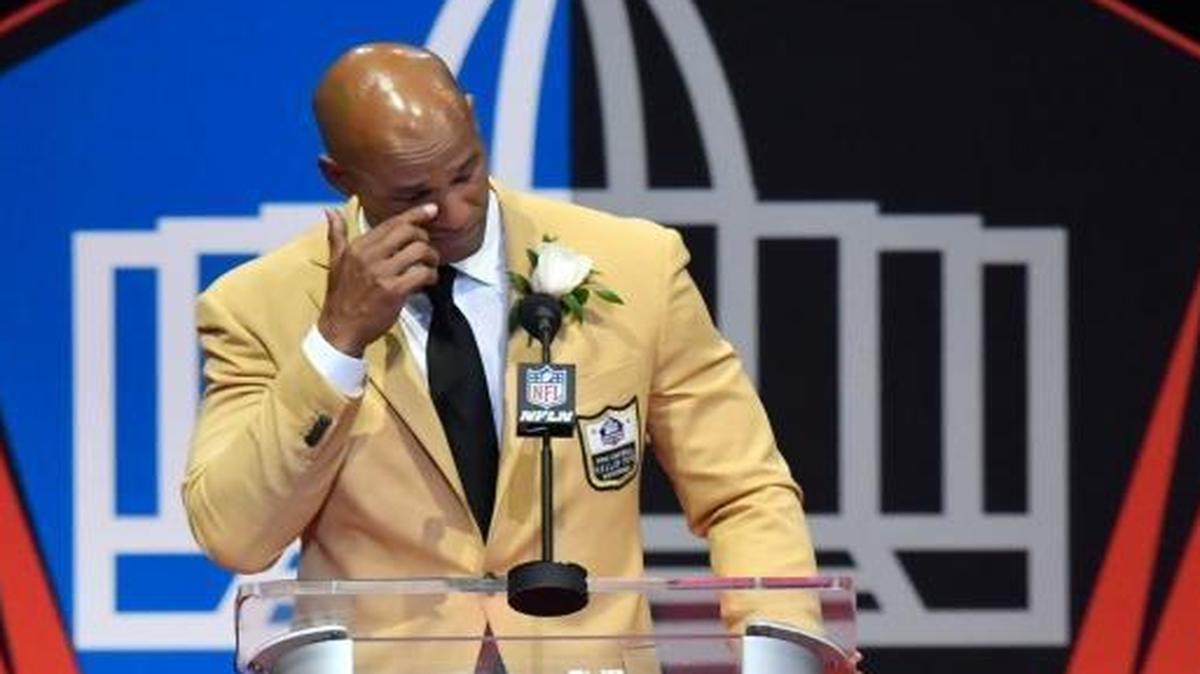 Jason Taylor wipes a tear from his eye as he delivers his speech at his induction, at the Pro Football Hall of Fame on Saturday, Aug. 5, 2017, in Canton, Ohio.