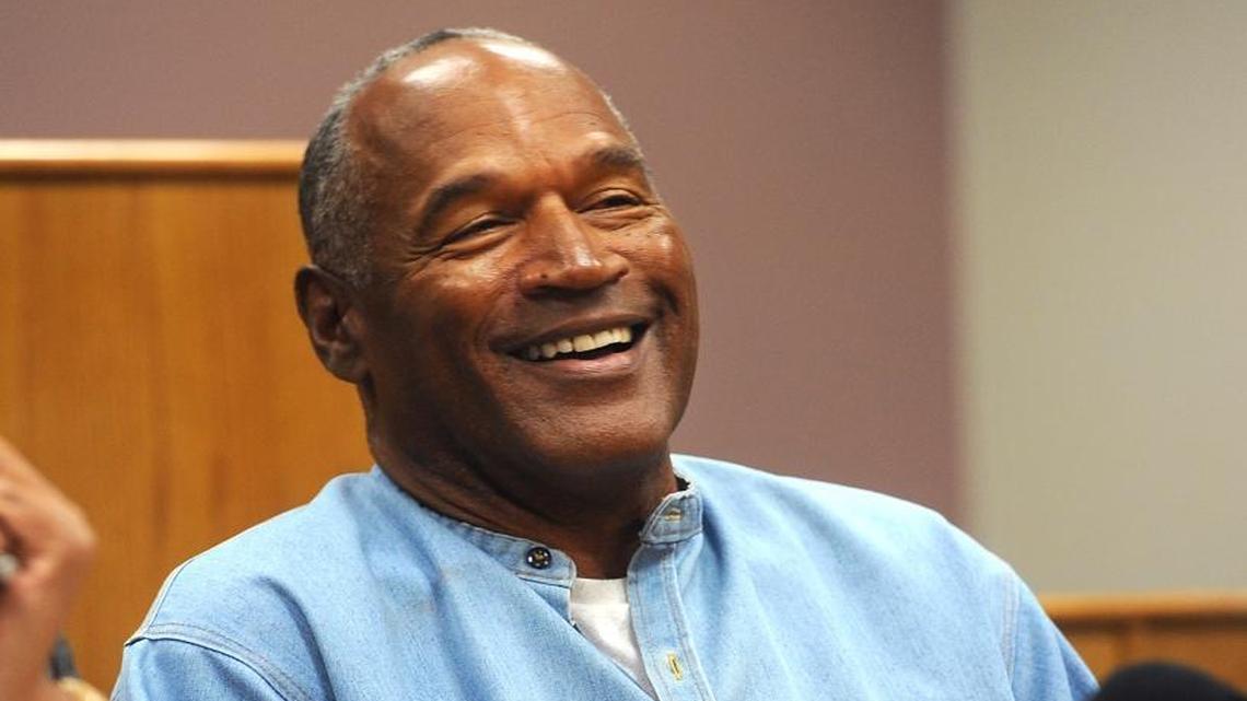 Former NFL football star O.J. Simpson laughs as he appears via video for his parole hearing at the Lovelock Correctional Center in Lovelock, Nev., on Thurs., July 20, 2017. Simpson was granted parole Thursday after more than eight years in prison for a Las Vegas hotel heist, successfully making his case in a nationally televised hearing that reflected America's enduring fascination with the former football star.