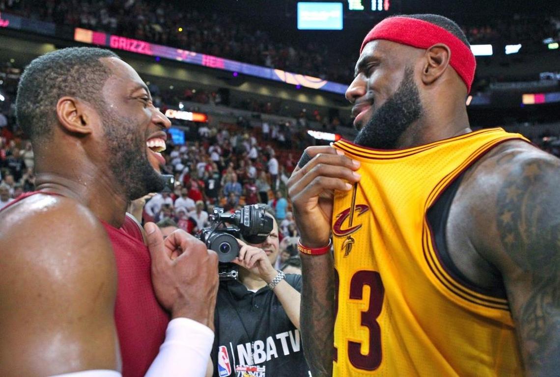 Miami Heat guard Dwyane Wade (3) talks with former teammate Cleveland Cavaliers forward LeBron James after an NBA basketball game at the AmericanAirlines Arena in Miami in this Thursday, Dec. 25, 2014, file photo.