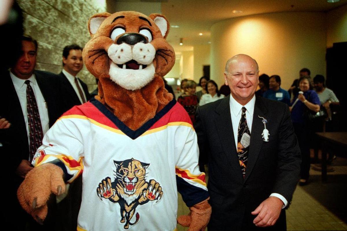 Wayne Huizenga walks with the Panther’s mascot on June 4, 1996.