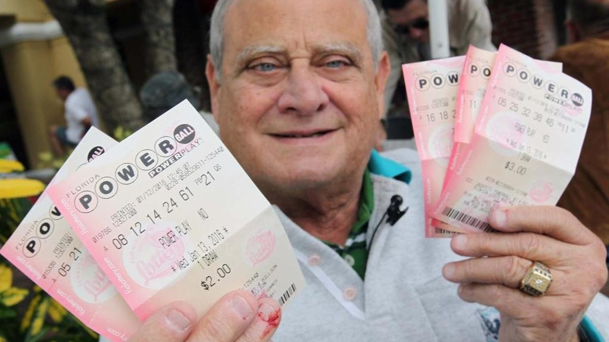 Arnoldo Muller shows off his Powerball tickets bought Wednesday, Jan. 13, 2016 in Coral Gables.
