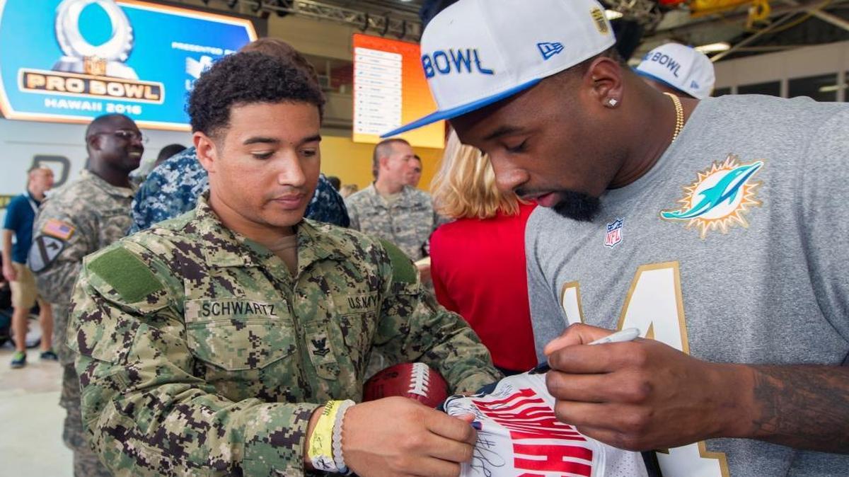Miami Dolphins receiver Jarvis Landry signs an autograph for Justin Schwartz of the U.S. Navy during the NFL Pro Bowl football draft show at Wheeler Army Airfield, Wednesday, Jan. 27, 2016, in Wahiawa, Hawaii.