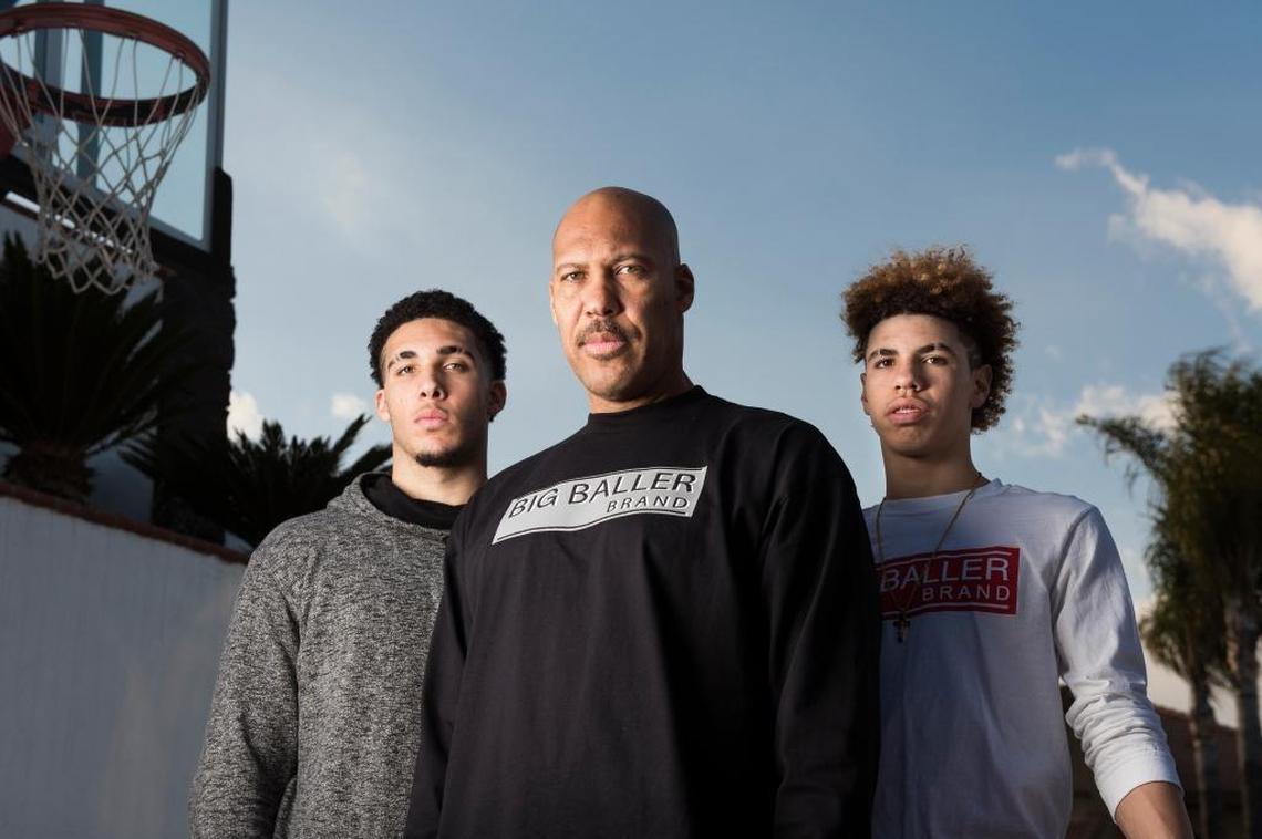 LaVar Ball, center, with his sons and Chino Hill High School basketball stars, LiAngelo, left, and LaMelo, right, on Feb. 22, 2017 at their home in Chino Hills, Calif. The family wears the Big Baller Brand line of clothing that LaVar started.