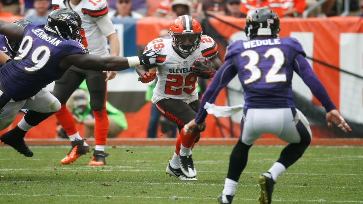 Duke Johnson, a former Miami Hurricane running back, now with the Cleveland Browns runs the ball against Baltimore Ravens strong safety Eric Weddle (32) in the first half of an NFL football game, Sun., Sept. 18, 2016, in Cleveland.