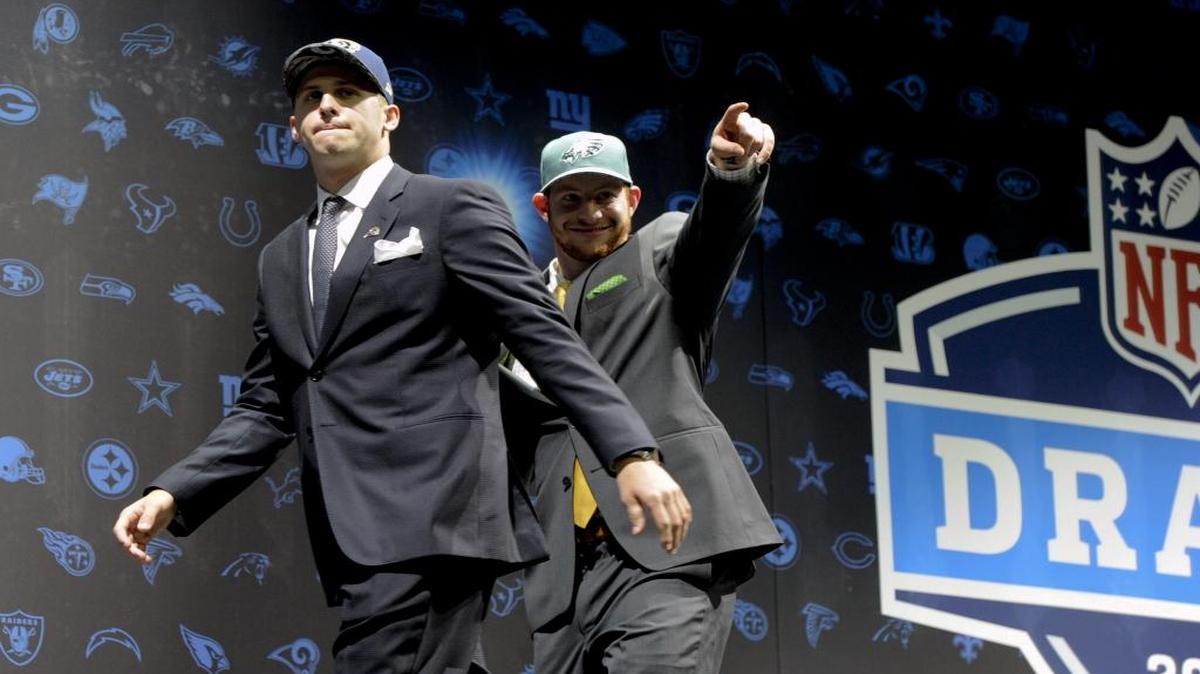Jared Goff, left, after being selected by Los Angeles Rams as their number one pick and Carson Wentz, after being selected by the Philadelphia Eagles as their number two pick in the first round of the 2016 NFL football draft greet fans at Selection Square in Grant Park, Thurs., April 28, 2016, in Chicago.