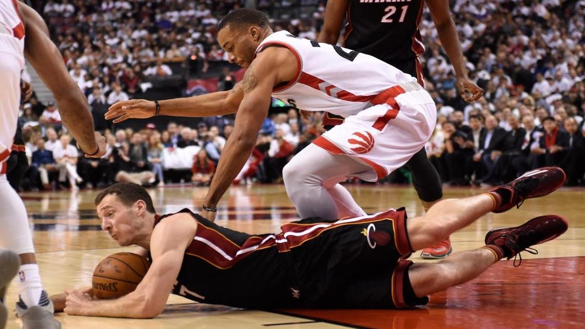 Miami Heat's Goran Dragic (7) dives for the ball as Toronto Raptors' Norman Powell defends during the second half in Game 1 of a second round NBA basketball playoff series in Toronto on Tues., May 3, 2016.
