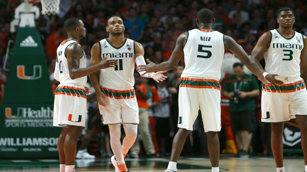 Miami Hurricanes guard Bruce Brown (11) is congratulated by teammates after a play during the second half of an NCAA college basketball game against the Duke Blue Devils at the Watsco Center in Coral Gables on Feb. 25, 2017.