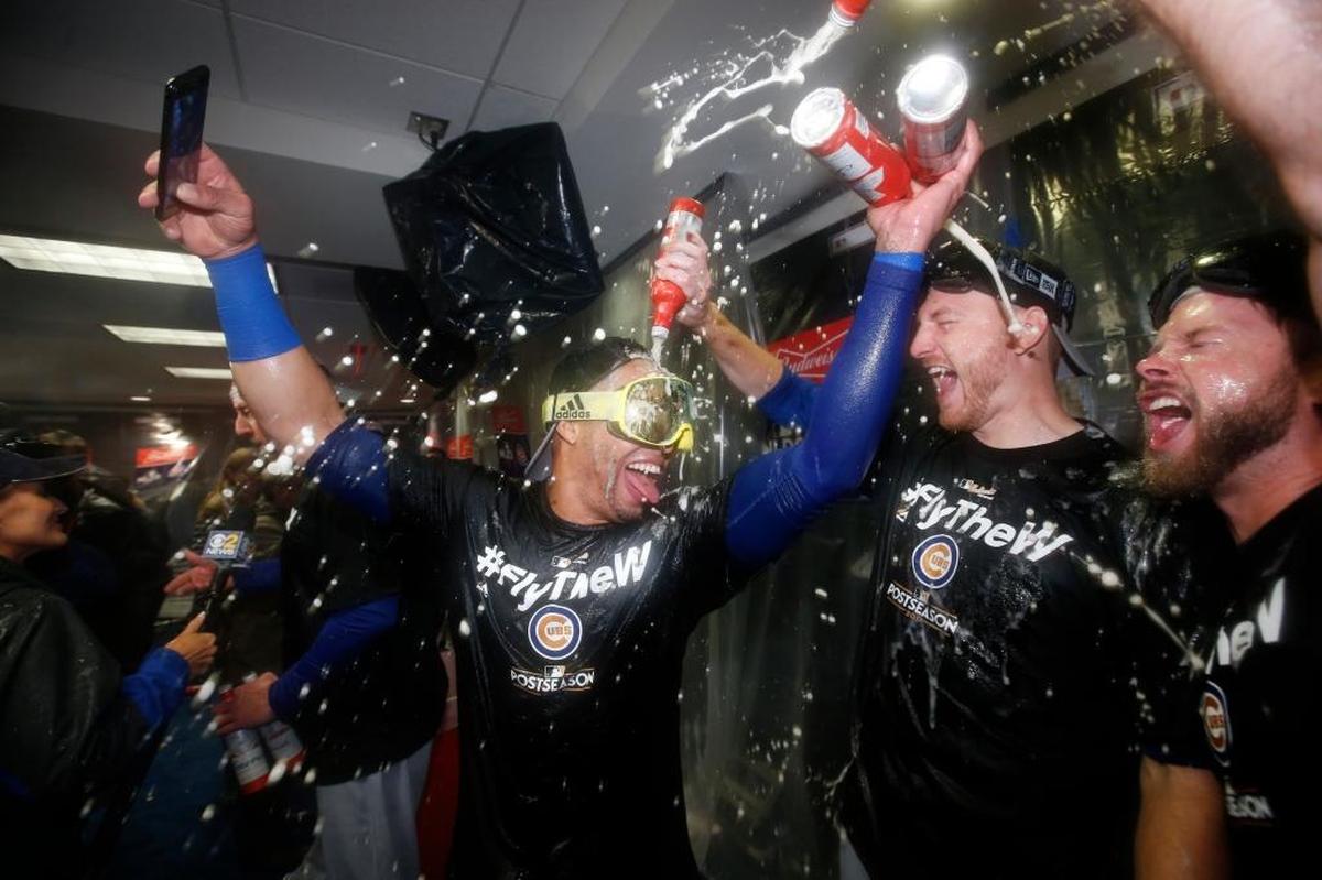 Members of the Chicago Cubs celebrate after Game 5 of baseball's National League Division Series against the Washington Nationals, at Nationals Park, Friday, Oct. 13, 2017, in Washington. The Cubs won 9-8.