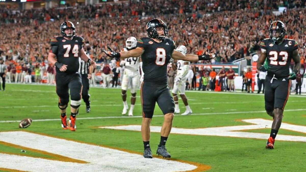 Miami Hurricanes Braxton Berrios (8) raises his hands after scoring a second quarter touchdown as they play Virginia Tech at Hard Rock Stadium in Miami Gardens, Florida, Nov. 4, 2017.