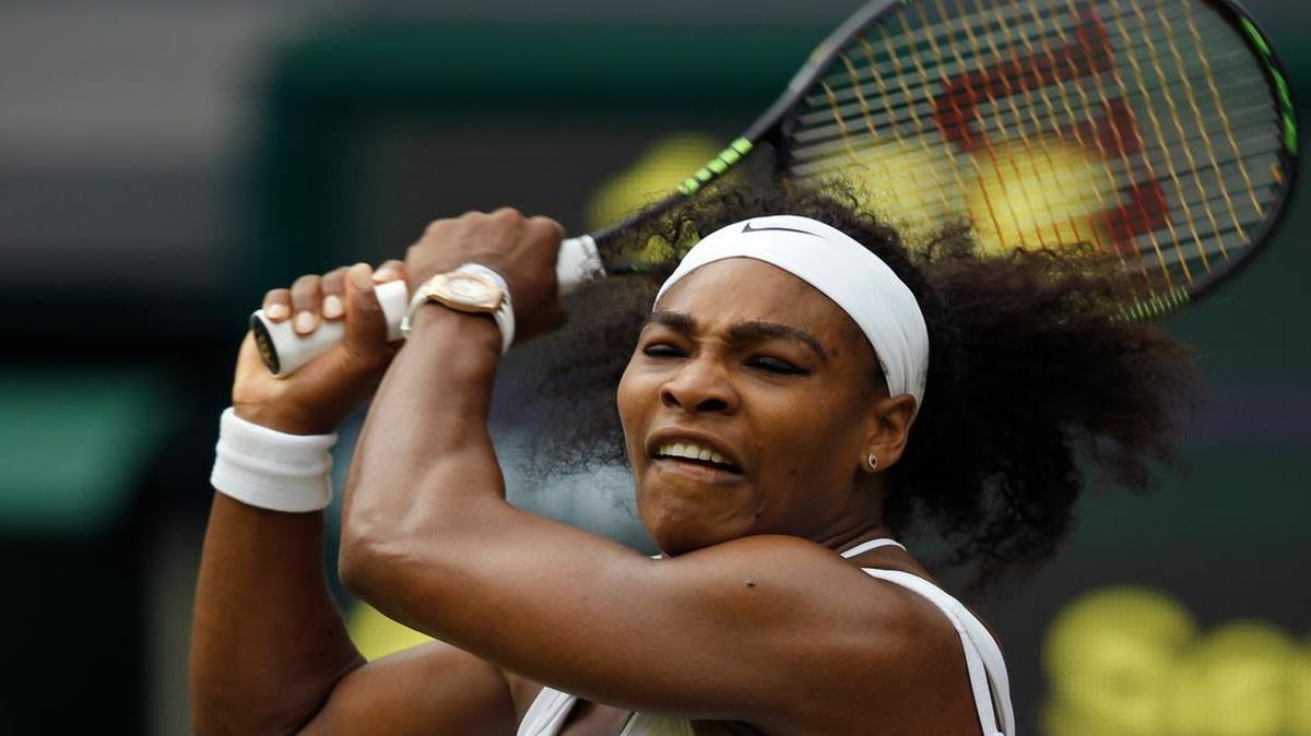 
Serena Williams makes a return to sister Venus Williams during their singles match against at the All England Lawn Tennis Championships in Wimbledon, London, Monday July 6, 2015.

