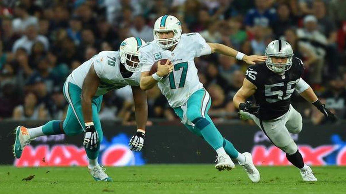 
Miami Dolphins QB Ryan Tannehill runs for yardage against the Oakland Raiders at Wembley Stadium in London, Sunday, Sept. 28, 2014.
