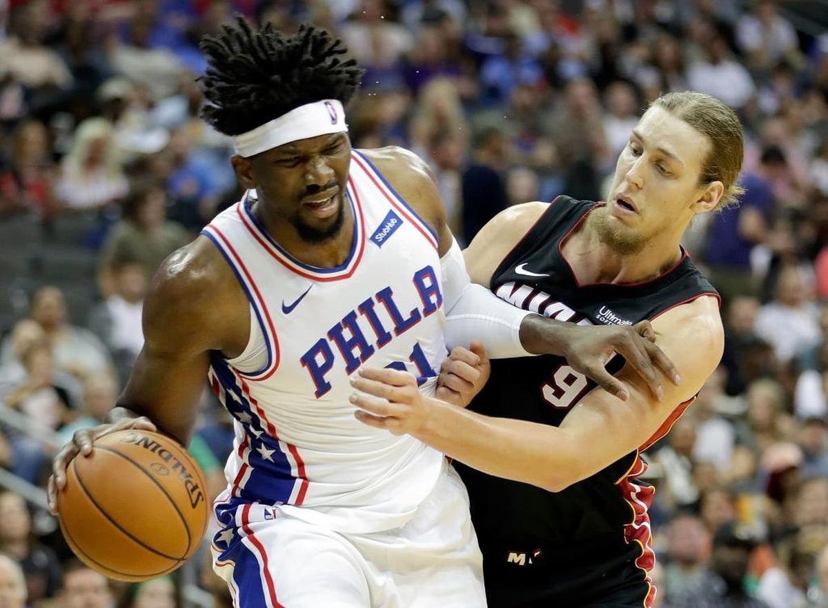 Philadelphia 76ers’ Joel Embiid (21) drives toward the basket as Miami Heat’s Kelly Olynyk (9) defends during the game at Sprint Center on Oct. 13, 2017 in Kansas City, Missouri.