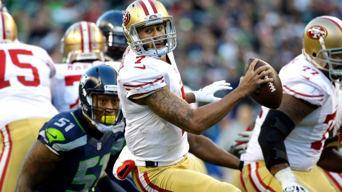 San Francisco 49ers quarterback Colin Kaepernick scrambles against the Seattle Seahawks, Sunday, Dec. 14, 2014, in Seattle.