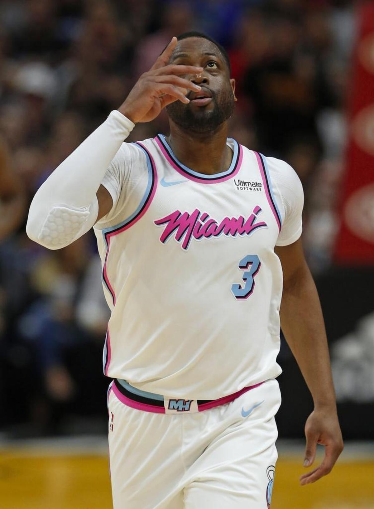 Miami Heat guard Dwyane Wade reacts after scoring his first basket of the NBA basketball against the Milwaukee Bucks during the first quarter at the AmericanAirlines Arena in Miami on Friday, Feb. 9, 2018.
