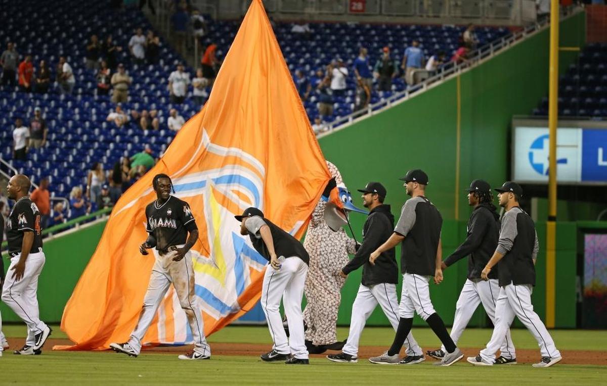 Billy the Marlin and Marlins players celebrate after a 2-1 win over the Chicago Cubs at Marlins Park on March 31, 2018, in Miami.