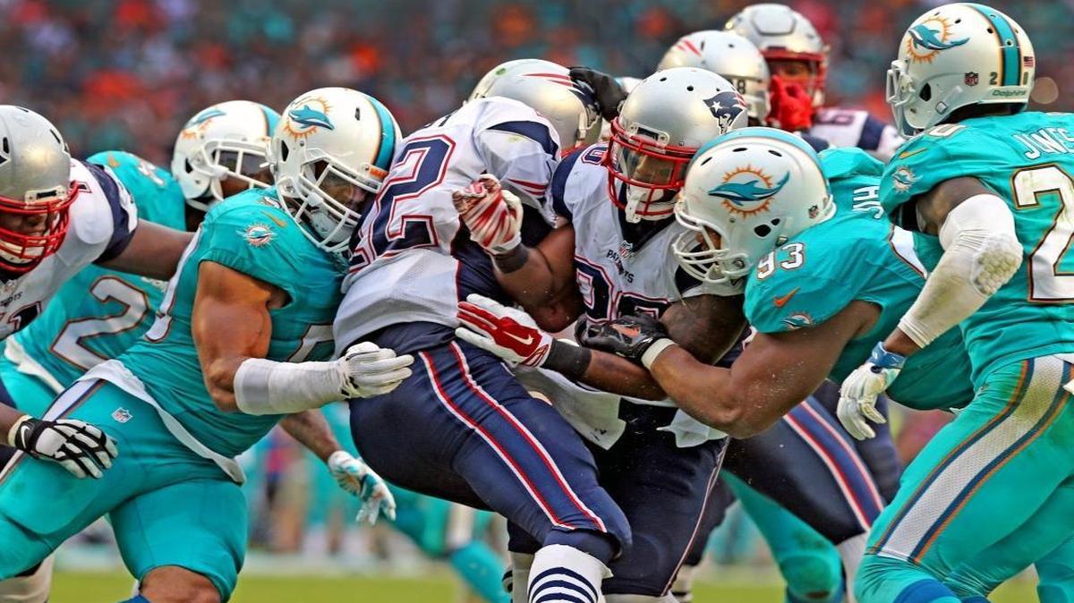Miami Dolphins defensive line sacks New England Patriots quarterback Tom Brady in the fourth quarter at Sun Life Stadium in Miami Gardens, Florida, Jan. 3, 2016.