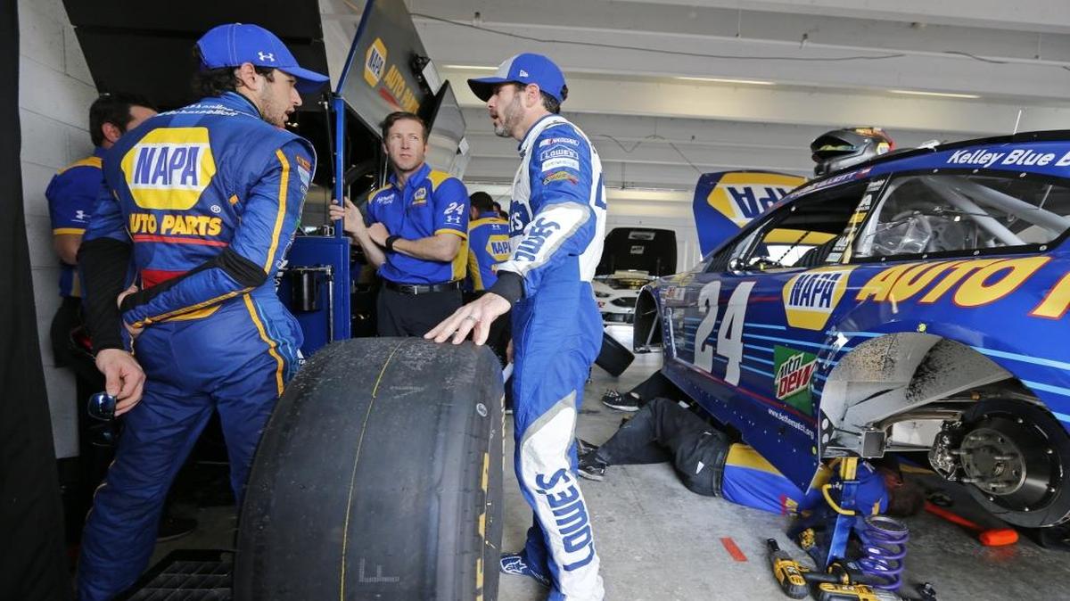 NASCAR drivers Chase Elliott, left, and Jimmie Johnson, right, in the garage during Championship Weekend at Homestead-Miami Speedway on Nov. 19, 2016