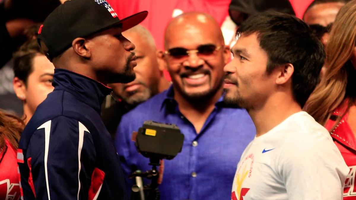 
Floyd Mayweather Jr., left, and Manny Pacquiao face off during their official weigh-in at MGM Grand Garden Arena in Las Vegas on May 1, 2015. The two will face each other in a welterweight unification bout on May 2, 2015 in Las Vegas.
