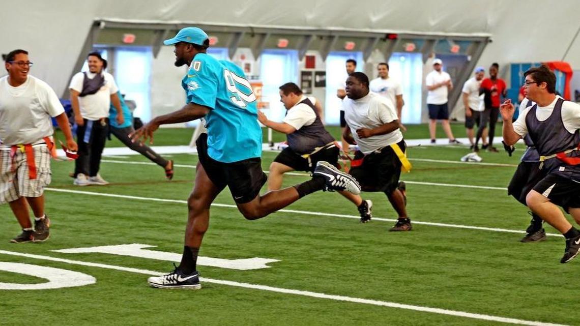 Miami Dolphins first round draft pick Charles Harris, 90, runs with kids during a flag football game at the Fins training camp, May 16, 2017. Members of the Miami Dolphins rookie class host Special Olympics Florida athletes from Broward and Miami-Dade counties to promote physical fitness in the South Florida community. Dolphins rookies will play flag football games and referee games with Special Olympics Florida athletes in grades 6th-12th.
