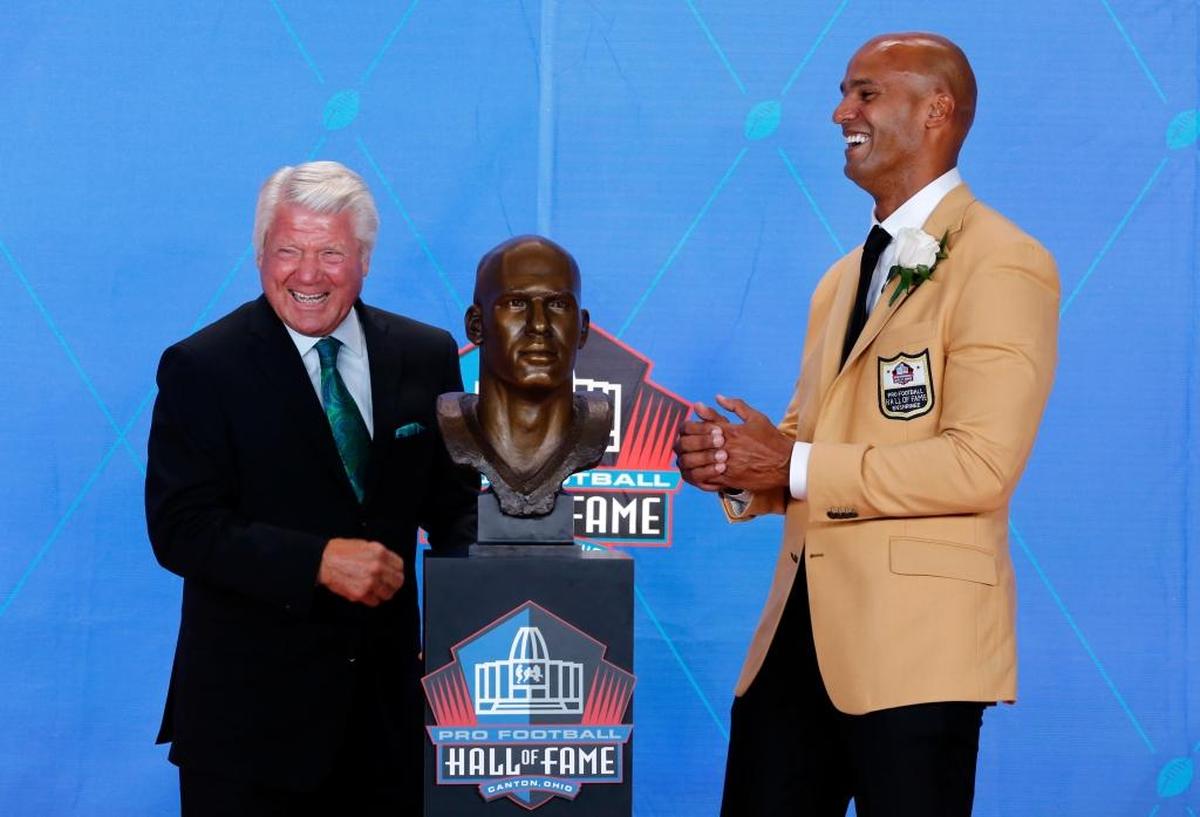 Jason Taylor, right, laughs with his presenter, former coach Jimmy Johnson, as they pose with Taylor's bust during inductions the Pro Football Hall of Fame, Saturday, Aug. 5, 2017,in Canton, Ohio.
