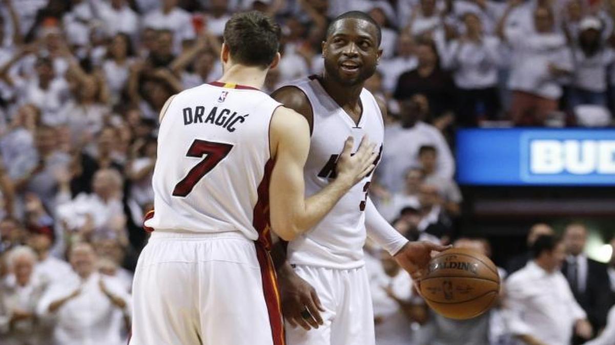 Miami Heat guard Goran Dragic, left, and guard Dwyane Wade react after the Heat defeat the Raptors 94-87 during Game 4 of the Heat-Raptors playoff series at the AmericanAirlines Arena in Miami on Mon., May 9, 2016.
