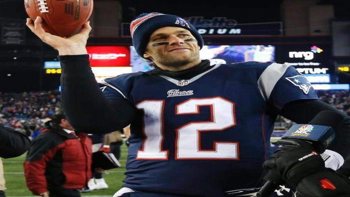 
New England Patriots quarterback Tom Brady holds up the game ball after an NFL divisional victory against the Baltimore Ravens on Saturday, Jan. 10, 2015, in Foxborough, Mass. 
