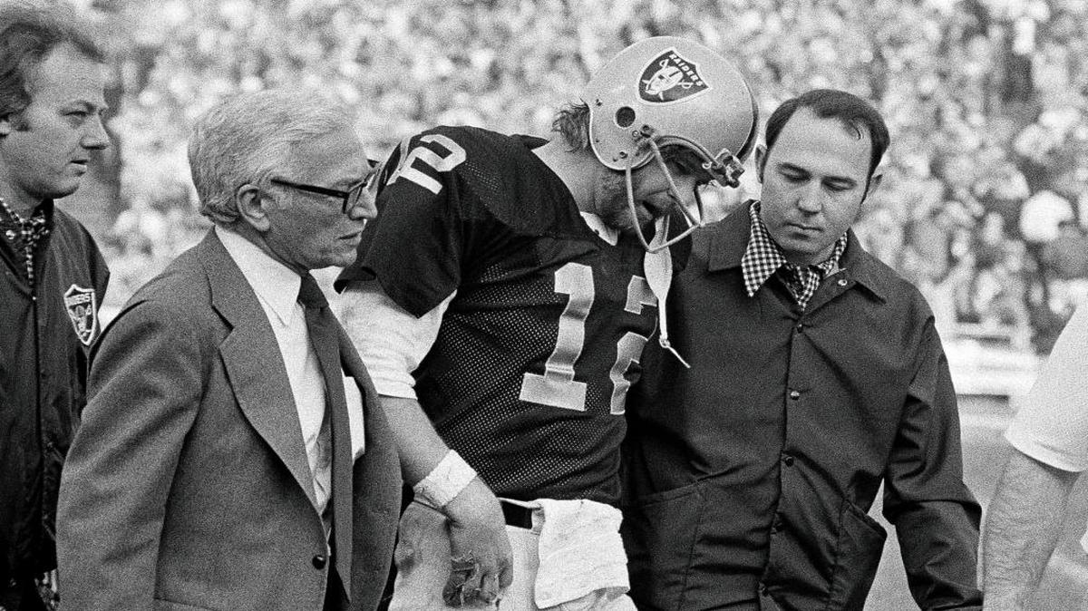 In this Dec. 26, 1976, file photo, Oakland Raiders quarterback Ken Stabler is helped from the field after a hard tackle by the Pittsburgh Steelers in the third quarter of theAFC championship NFL football game in Oakland, Calif. Stabler, the late NFL MVP and Super Bowl winner who is a finalist for the Pro Football Hall of Fame, has been diagnosed with the brain disease CTE, Boston University researchers say.