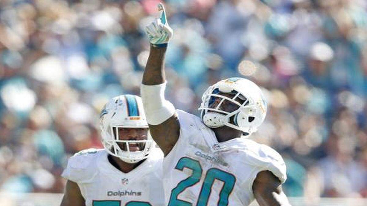 

Pressure defense: Dolphins safety Reshad Jones (20) celebrates with linebacker Jelani Jenkins after Jones sacked Jaguars quarterback Blake Bortles.

