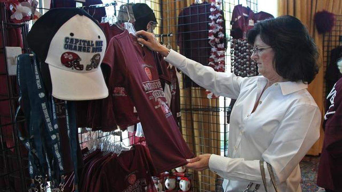 
South Florida attractions: Teri Spain of Booneville, Mississippi, shops for team apparel while in town for the Orange Bowl game. Mississippi State fans purchased team apparel inside the pop-up store at Trump National Doral, the official hotel for Mississippi State, prior to the Orange Bowl game against Georgia Tech.

