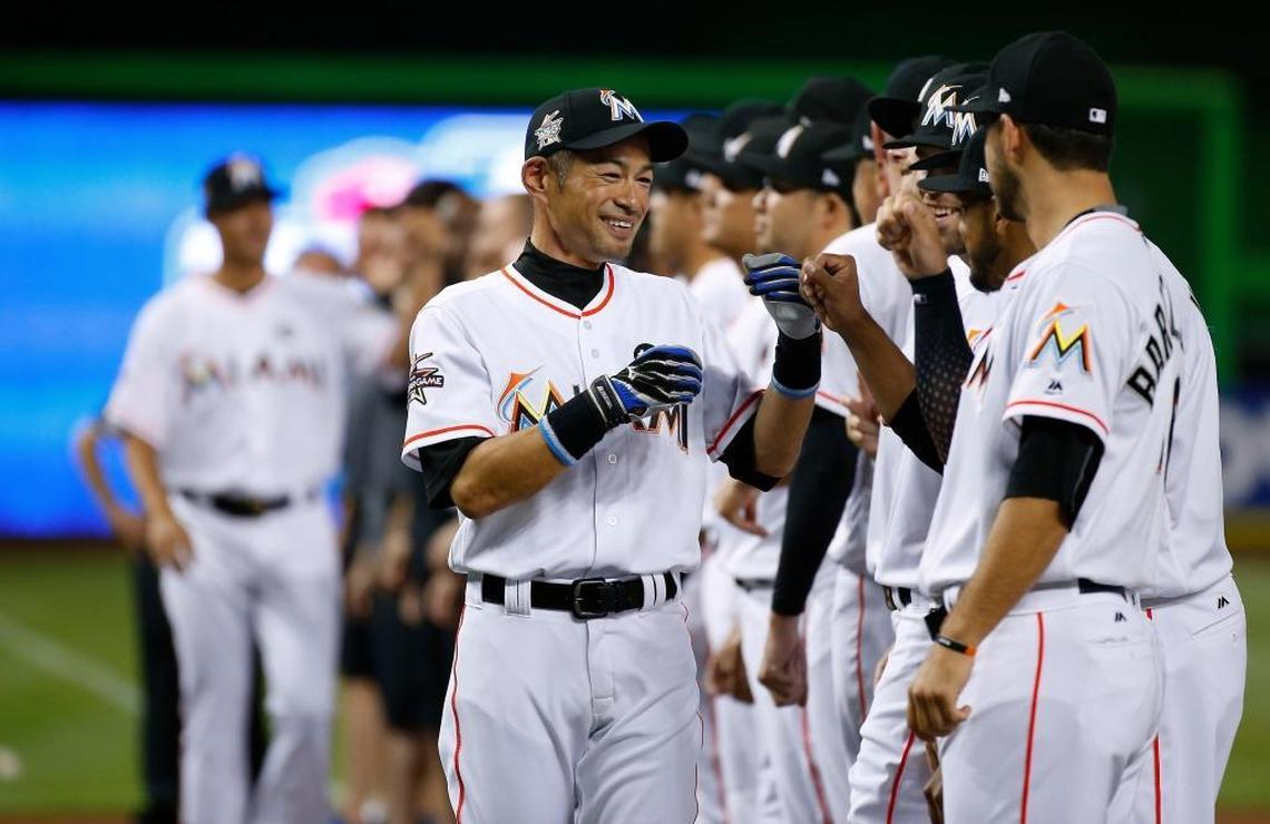 Miami Marlins outfielder Ichiro Suzuki high fives teammates before the start of the Miami Marlins’ home opener against the Atlanta Braves at Marlins Park on April 11, 2017.