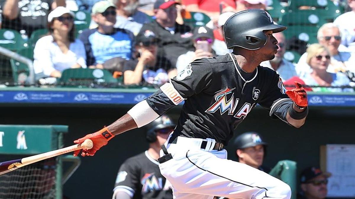 Miami Marlins second baseman Dee Gordon hits a double in the first inning of the team’s game against the New York Mets at Roger Dean Stadium in Jupiter on March 15, 2017.