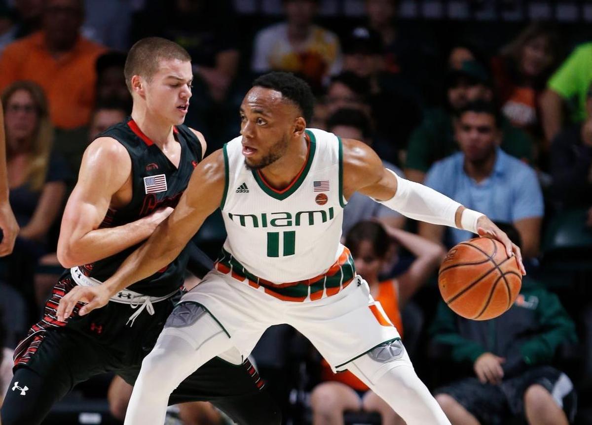 Miami guard Bruce Brown Jr. (11) drives up against Gardner Webb guard Liam O'Reilly during the first half of an NCAA college basketball game, Friday, Nov. 10, 2017, in Coral Gables, Fla.