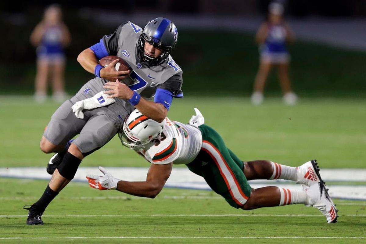 Trent Harris (33), a defensive end for UM at the time, tackles Duke quarterback Daniel Jones during the first half of game in Durham, N.C., on Sept. 29, 2017. The Dolphins are working out Jones this week.