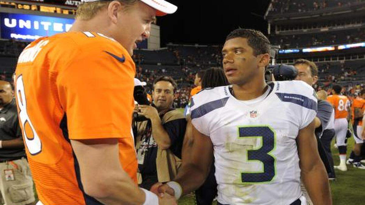 
Denver Broncos quarterback Peyton Manning (18) shakes hands with Seattle Seahawks quarterback Russell Wilson (3) following an NFL football preseason game in Denver.
