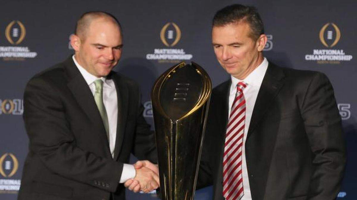 
Oregon head coach Mark Elfrich, left, and Ohio State head coach Urban Meyer both have eyes on the prize as they shake hands at the conclusion of a news conference on Sunday, Jan. 11, 2015, at the Renaissance Hotel in Dallas. The two teams meet for the national championship on Monday.
