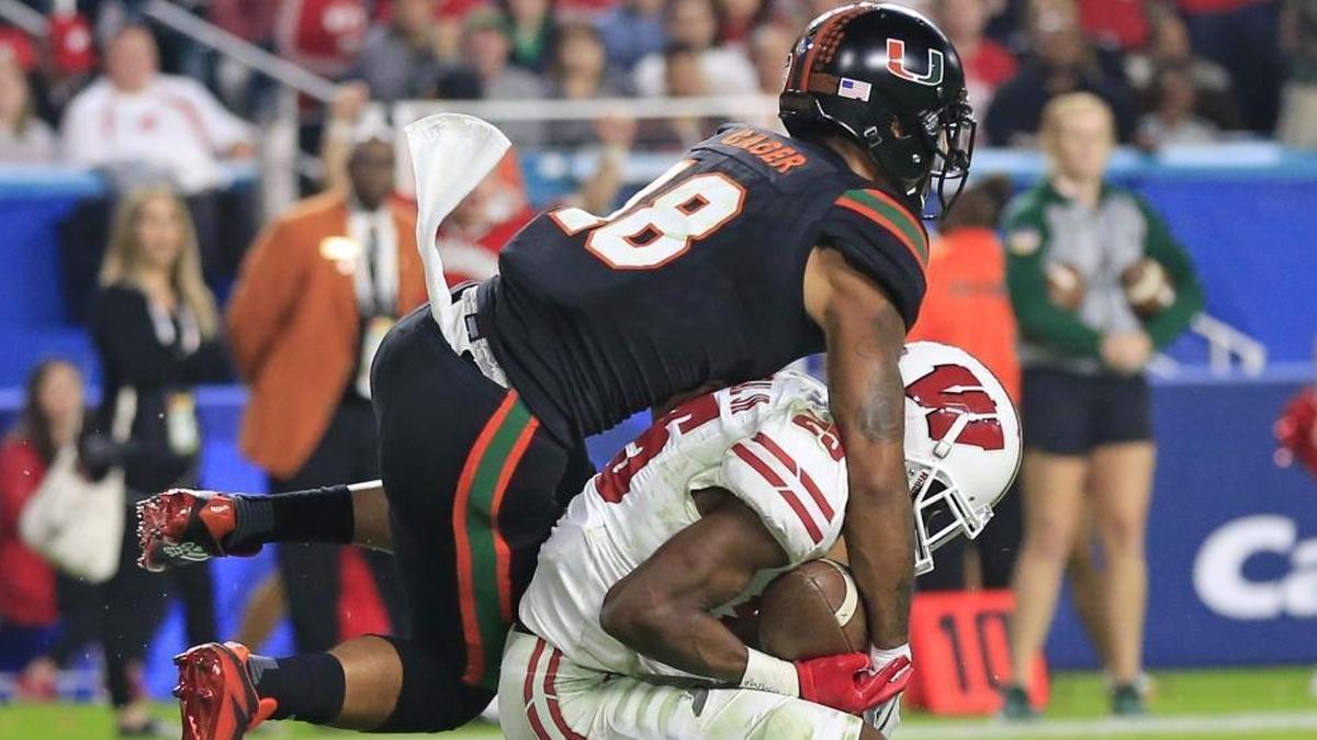 Wisconsin Badgers cornerback Derrick Tindal (25) intercepts the ball in the end zone intended for Miami Hurricanes wide receiver Lawrence Cager (18) in the third quarter as the University of Miami Hurricanes take on the Wisconsin Badgers on Saturday, Dec. 30, 2017.