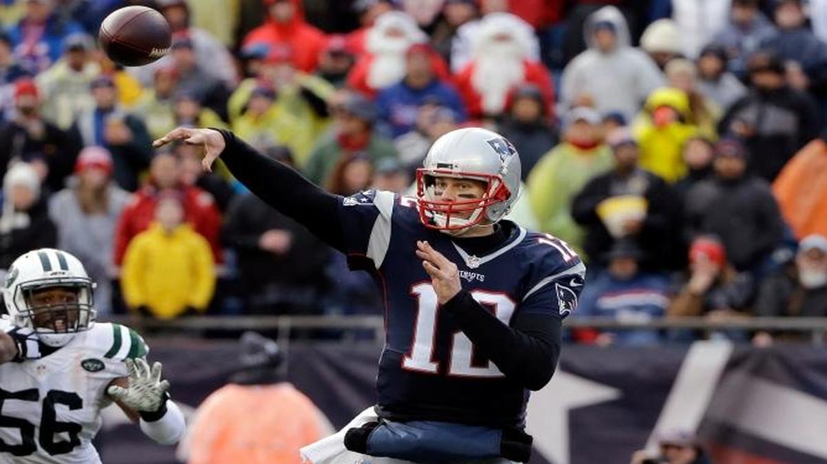 New England Patriots quarterback Tom Brady (12) passes under pressure from New York Jets linebacker Freddie Bishop (56) as Patriots lineman Marcus Cannon (61) blocks during the second half of an NFL football game, Sat., Dec. 24, 2016, in Foxborough, Mass.