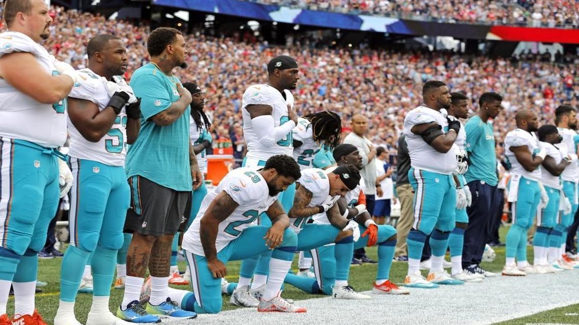 Miami Dolphins Arian Foster (29) wide receiver Kenny Stills (10) and free safety Michael Thomas (31) take a knee during the National Anthem before the game as the New England Patriots host the Miami Dolphins at Gillette Stadium on Sun., Sept. 18, 2016.