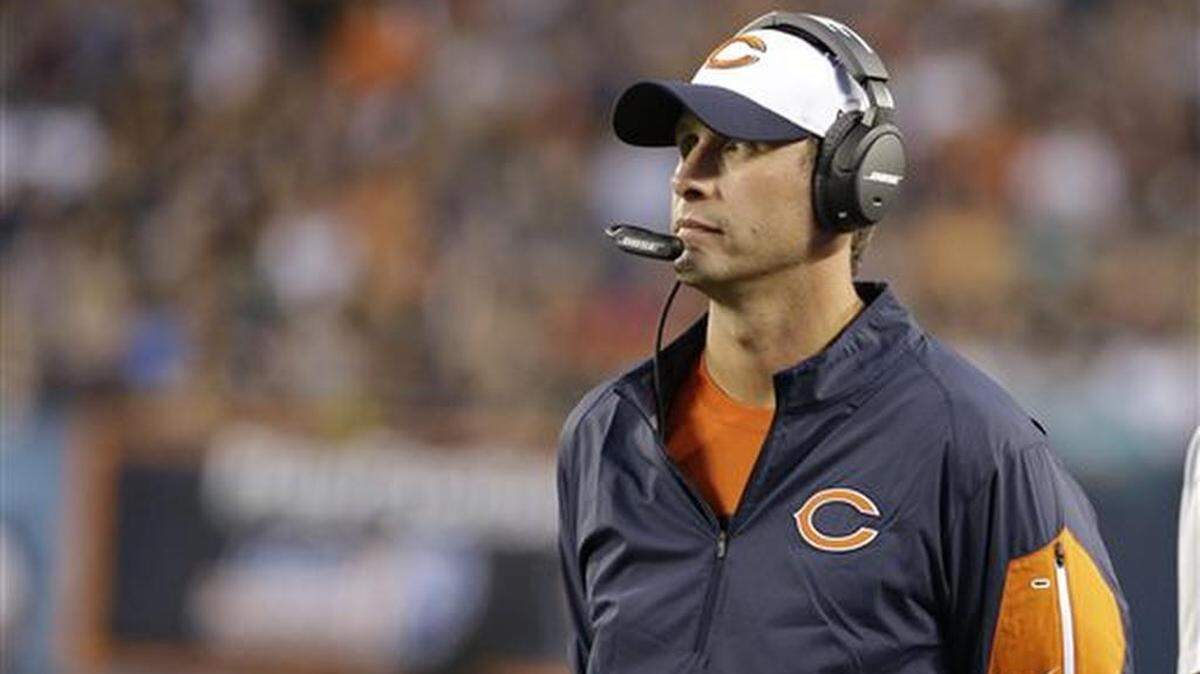 FILE - In this Aug. 13, 2015, file photo, Chicago Bears offensive coordinator Adam Gase watches during the first half of an NFL preseason football game against the Miami Dolphins in Chicago. Gase was hired Saturday, Jan. 9, 2016, as the Miami Dolphins' ninth coach since 2004, and he'll try to end the team's seven-year playoff drought.