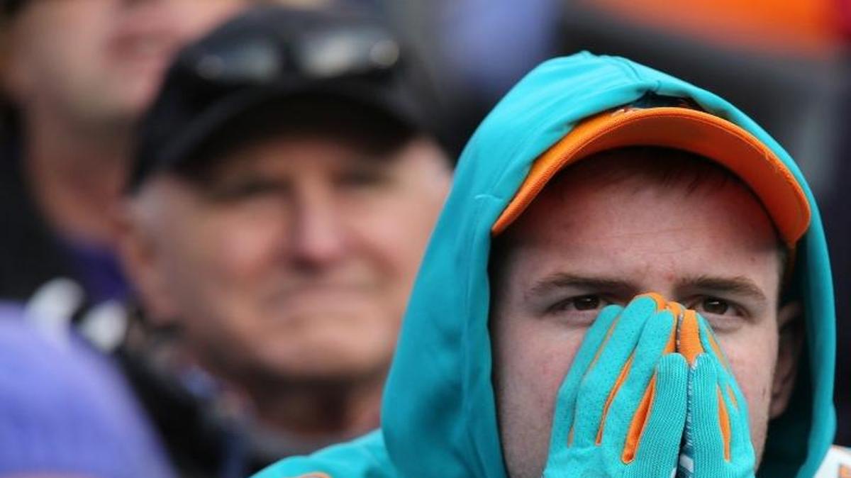 A Miami Dolphins fan watches as the Dolphins are defeated by the Baltimore Ravens at M&T Bank Stadium in Baltimore on December 4, 2016.