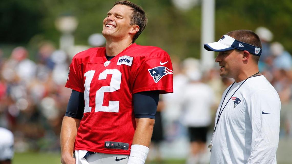 
New England Patriots quarterback Tom Brady shares a laugh with offensive coordinator Josh McDaniels during a joint practice between the Patriots and New Orleans Saints Wednesday, Aug.19, 2015, in White Sulphur Springs, W.Va. 
