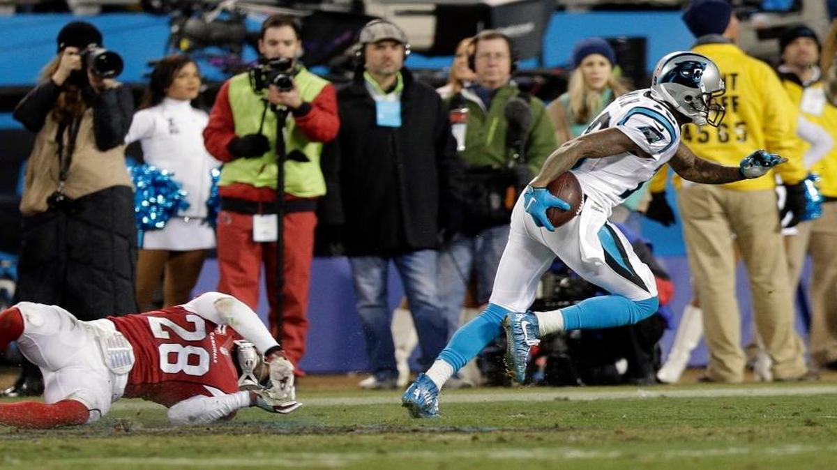 Carolina Panthers' Ted Ginn gets past Arizona Cardinals' Justin Bethel for a touchdown run during the first half the NFL football NFC Championship game Sunday, Jan. 24, 2016, in Charlotte, N.C.