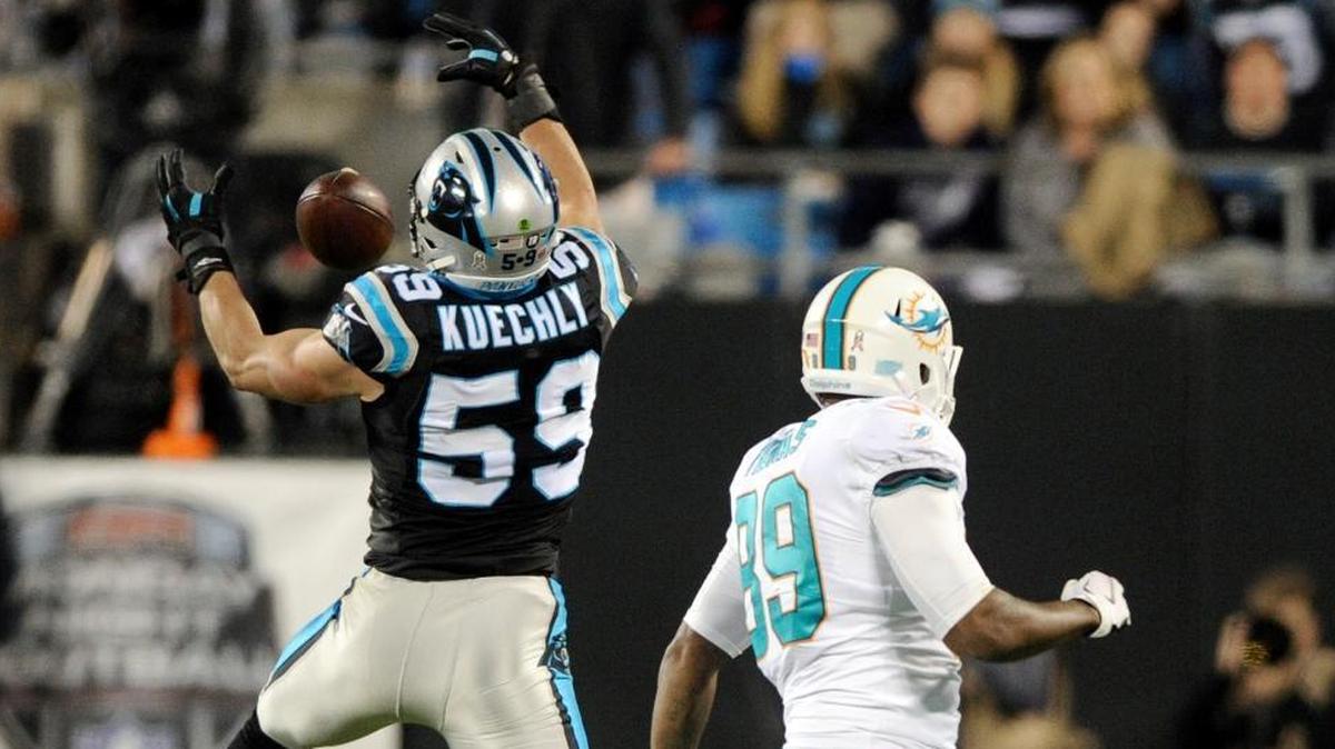 Carolina Panthers' Luke Kuechly (59) intercepts a pass intended for Miami Dolphins' Julius Thomas (89) in the first half of an NFL football game in Charlotte, N.C., Mon., Nov. 13, 2017.