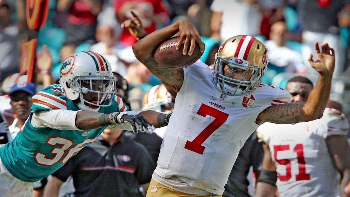Miami Dolphins Tony Lippet pushes San Francisco 49ers Colin Kaepernick out of bounds in the second quarter at Hard Rock Stadium in Miami Gardens, Florida, Nov. 27, 2016.