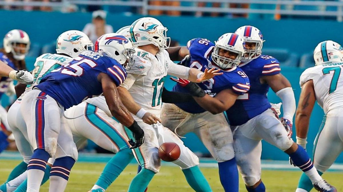 Miami Dolphins quaterback Ryan Tannehill gets the ball forced form his hand by the Buffalo Bills defense in the fourth quarter at Sun Life Stadium in Miami Gardens on Sept. 27, 2015.
