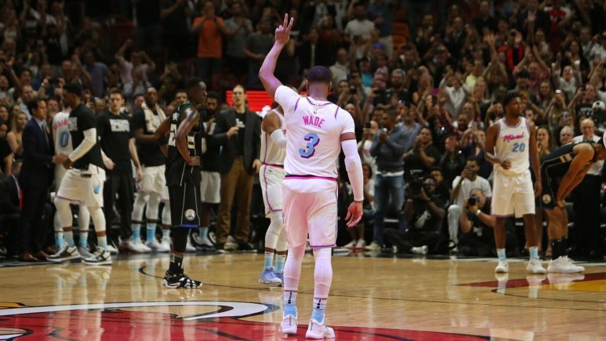 Miami Heat fans show their support as Heat guard Dwyane Wade enter the game during the first quarter of the NBA basketball against the Milwaukee Bucks at the AmericanAirlines Arena in Miami on Friday, Feb. 9, 2018.