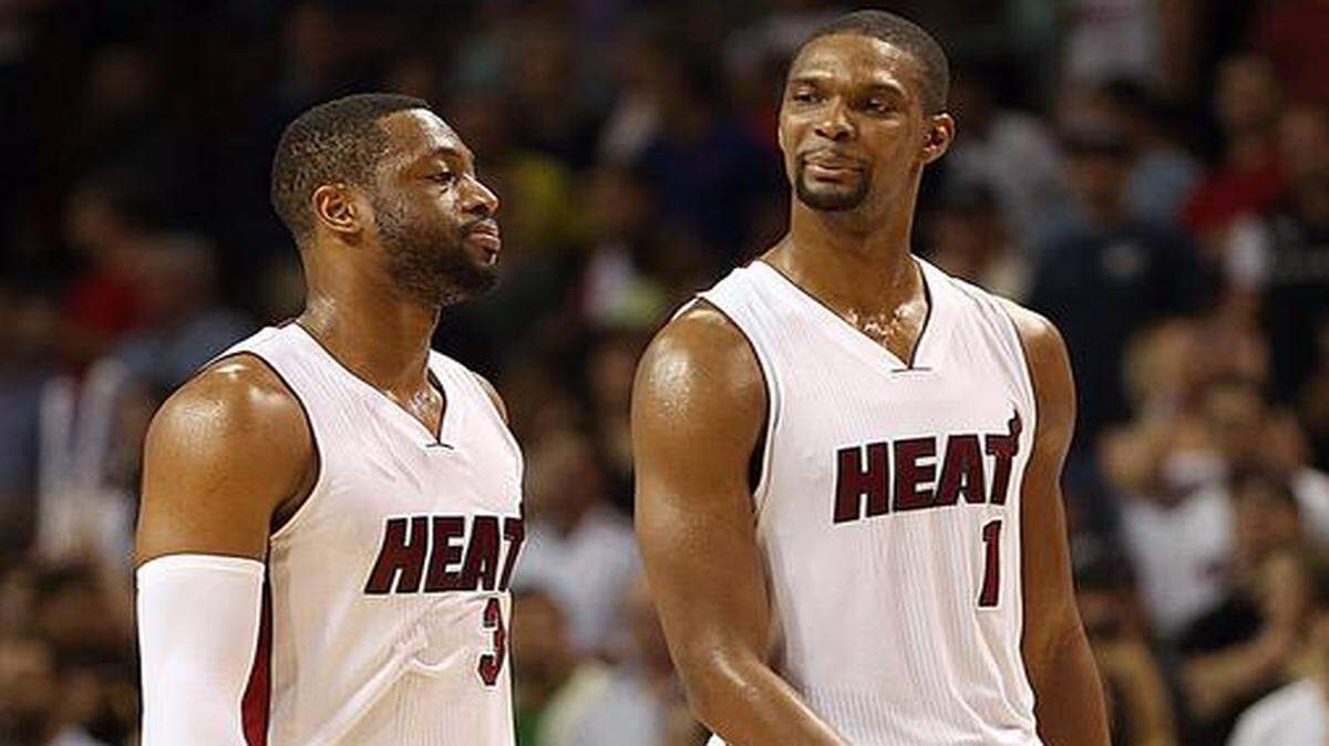 
Miami Heat’s Dwyane Wade and Chris Bosh react during a loss to the Orlando Magic on Monday, Dec. 29, 2014.
