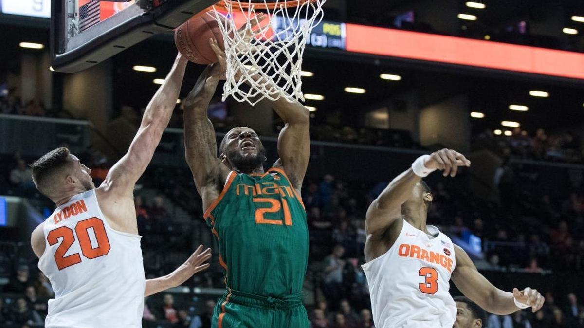 Miami forward Kamari Murphy (21) goes to the basket past Syracuse forward Tyler Lydon (20) and guard Andrew White III (3) during the first half of an NCAA college basketball game in the Atlantic Coast Conference tournament, Wed., March 8, 2017, in New York.
